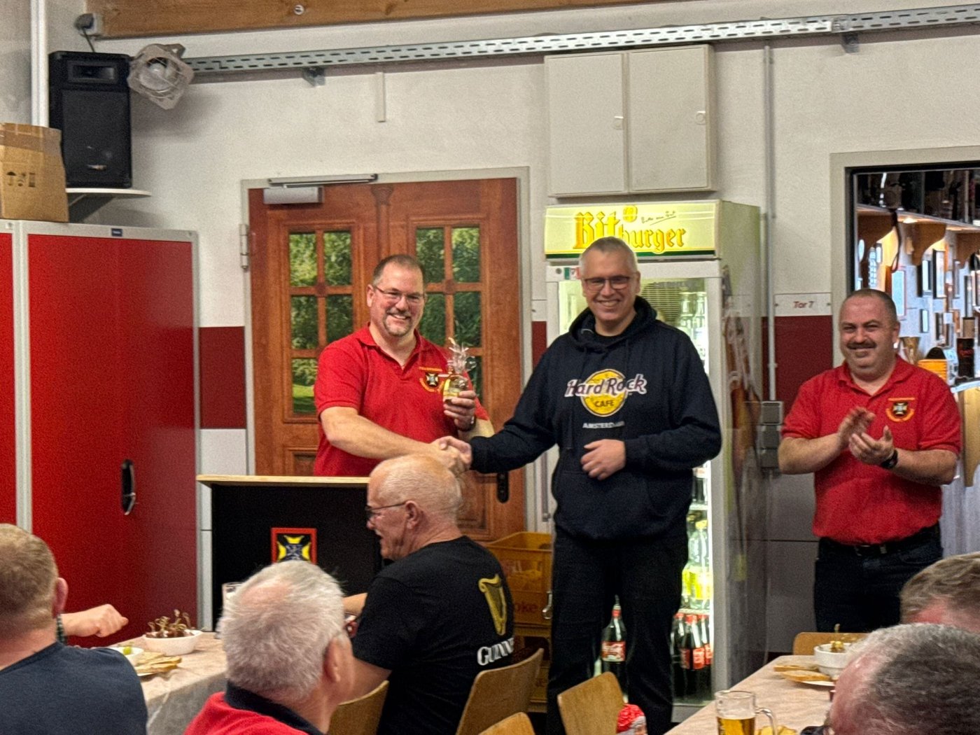 Olaf Jorzyk übergibt bei der Abschlussübung der Feuerwehr Ludweiler ein Glas Honig per Handschlag